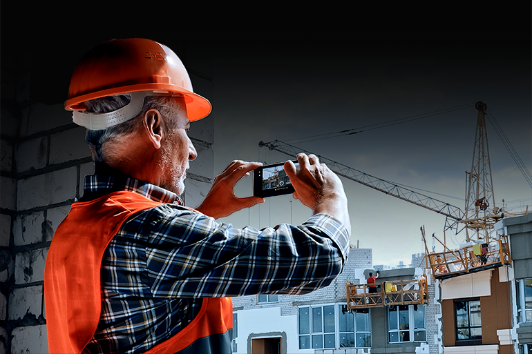 Construction worker documenting field work